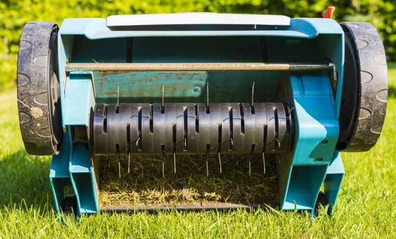 Lawn aerator on green grass